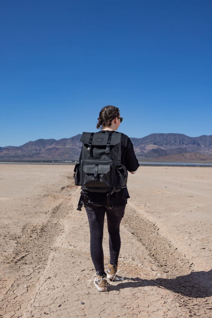 Photographer walking through desert wearing a Langly Alpha Globetrotter XC Camera Bag